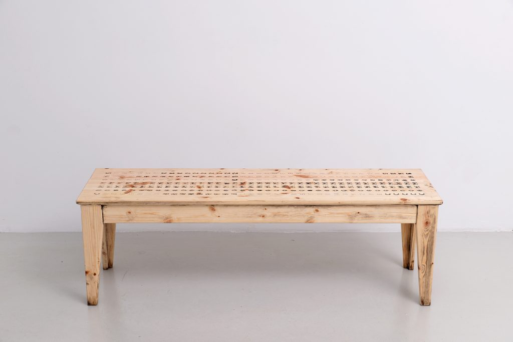 Société Réaliste, Commons to Kommerz back to Commons, 2014, Perforated wooden bench, 45 x 137.5 x 38 cm © Aurélien Mole